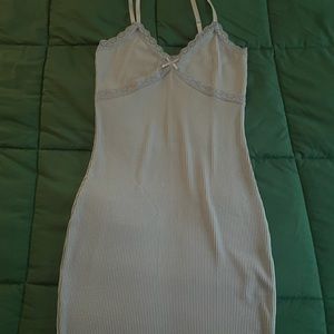 Never worn, blue lacey outlined dress with a tie in the middle.